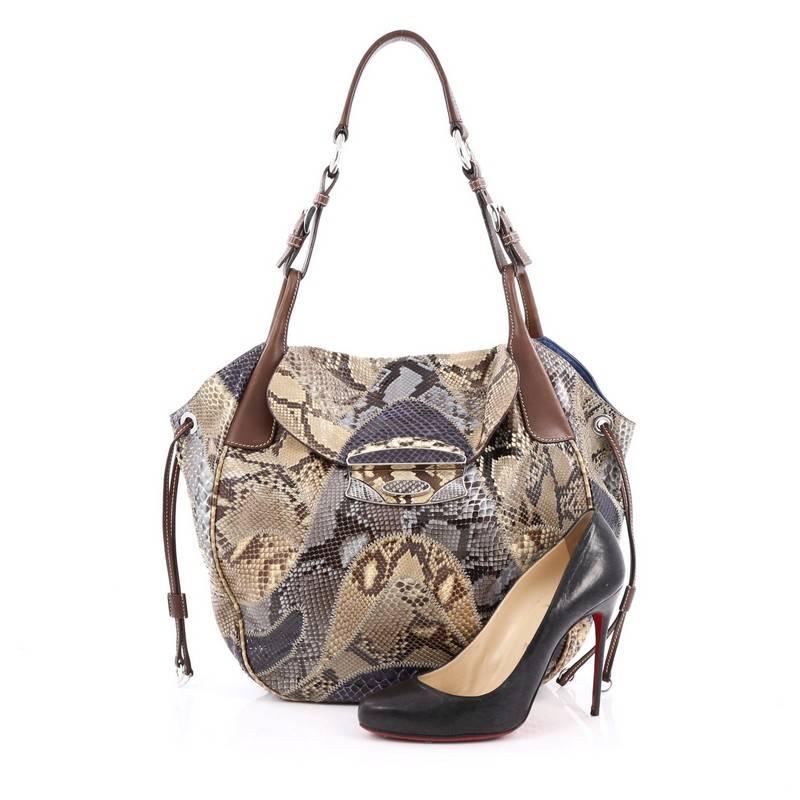 This authentic Prada Pushlock Tote Patchwork Python Large is edgy and stylish perfect for everyday use. Crafted from multicolor patchwork genuine python skin with brown leather trims, this exotic bag features a looping leather top handles with