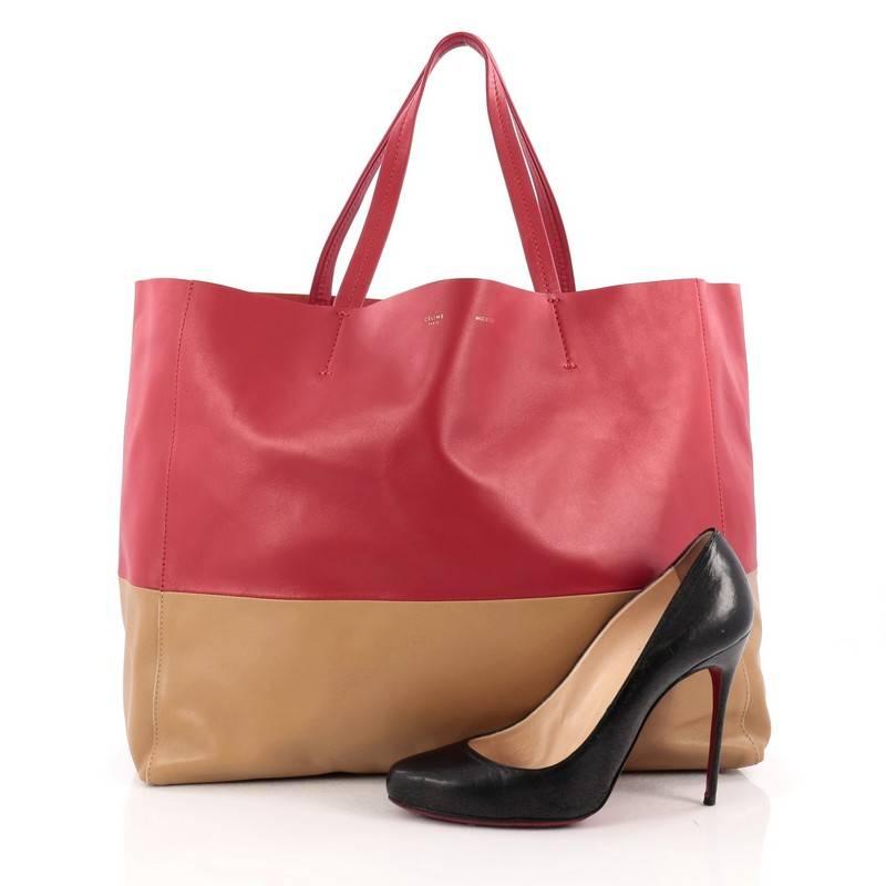 This authentic Celine Horizontal Bi-Cabas Tote Leather Large is the perfect oversized easy companion to fit all your essentials and more. Crafted in bicolor beige and red leather in a minimalist design, this no-fuss tote features dual flat leather