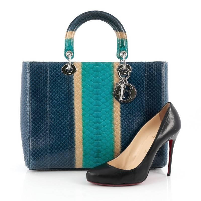 This authentic Christian Dior Lady Dior Handbag Python Large is an elegant and eye-catching piece made for the most daring of fashionistas. Crafted from genuine blue, turquoise and beige python skin, this boxy, large tote features short dual