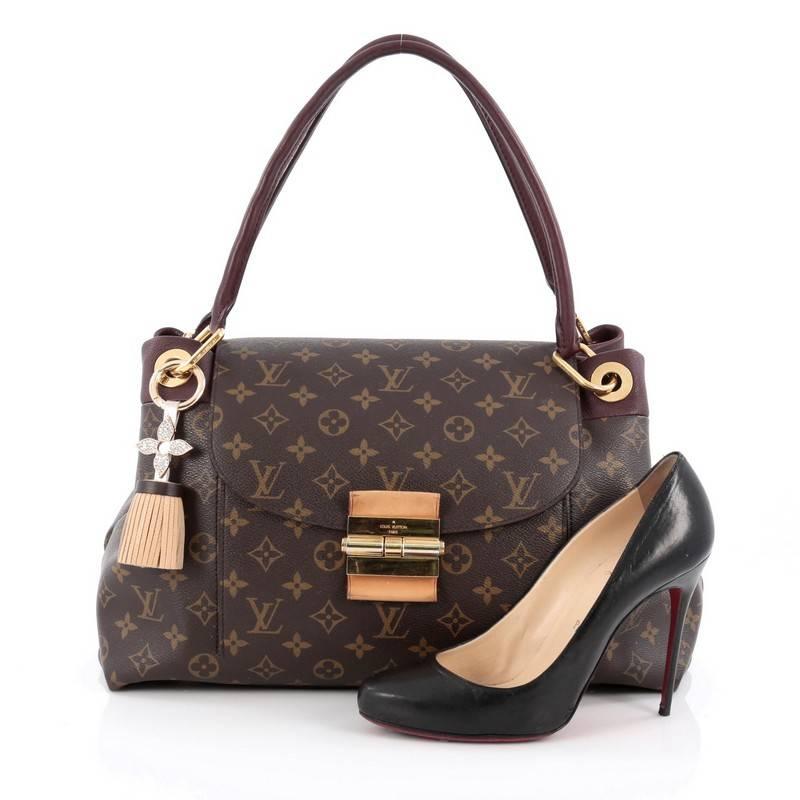 This authentic Louis Vuitton Olympe Handbag Monogram Canvas showcases the brand's heritage-inspired style with an added sophistication. Crafted from Louis Vuitton’s signature brown monogram coated canvas and bordeaux red leather trims, this sturdy