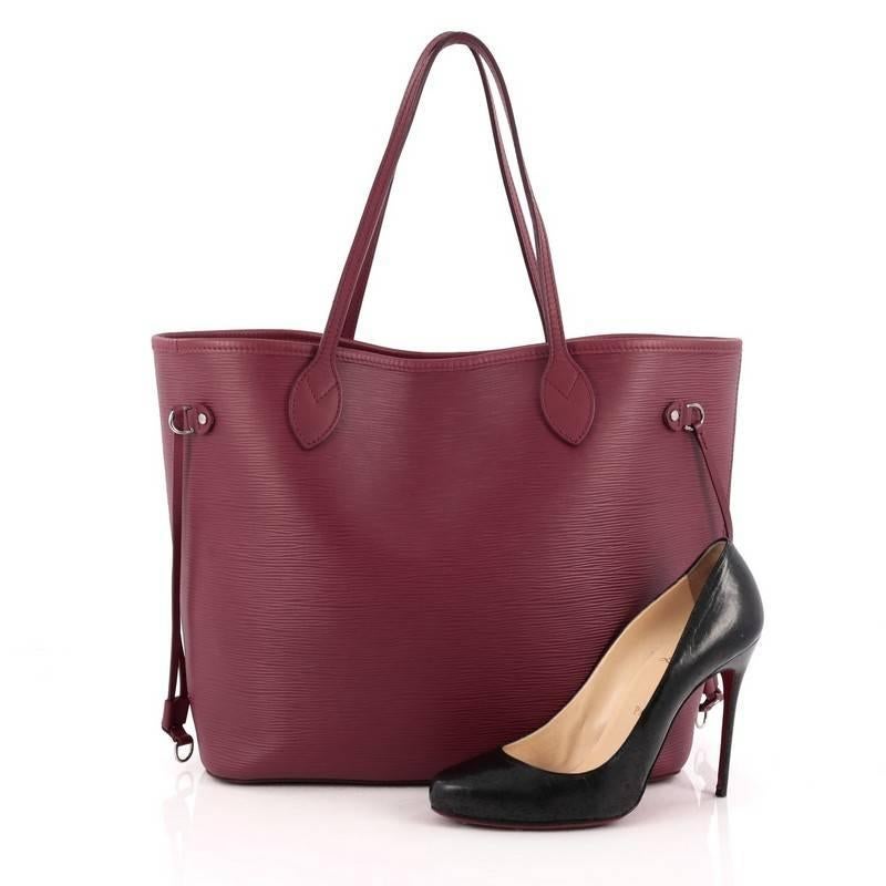This authentic Louis Vuitton Neverfull Tote Epi Leather MM is a perfect companion for daily excursions. Crafted in plum epi leather, this iconic, easy-to-carry tote features dual flat leather handles, side tassels that cinches and expands and