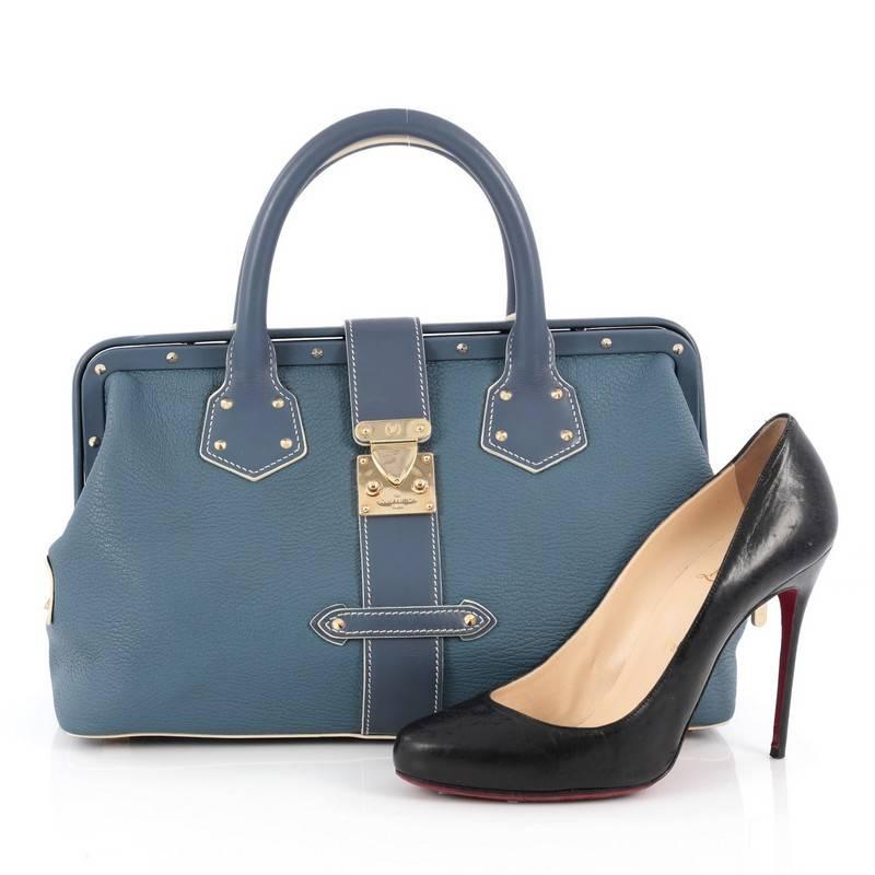 This authentic Louis Vuitton Suhali L'ingenieux Handbag Leather PM is a bright and glamorous satchel that adds a stylish touch to your look. Crafted from blue suhali goat leather, this doctor frame bag features, zipped side pockets, protective feet,
