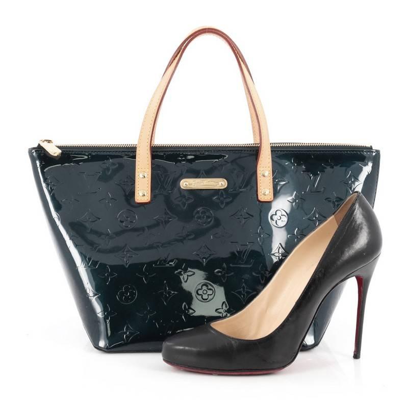 This authentic Louis Vuitton Bellevue Handbag Monogram Vernis PM is stylish yet functional tote perfect for everyday use. Crafted from Louis Vuitton's blue nuit monogram vernis embossed leather, this chic tote features dual flat vachetta leather