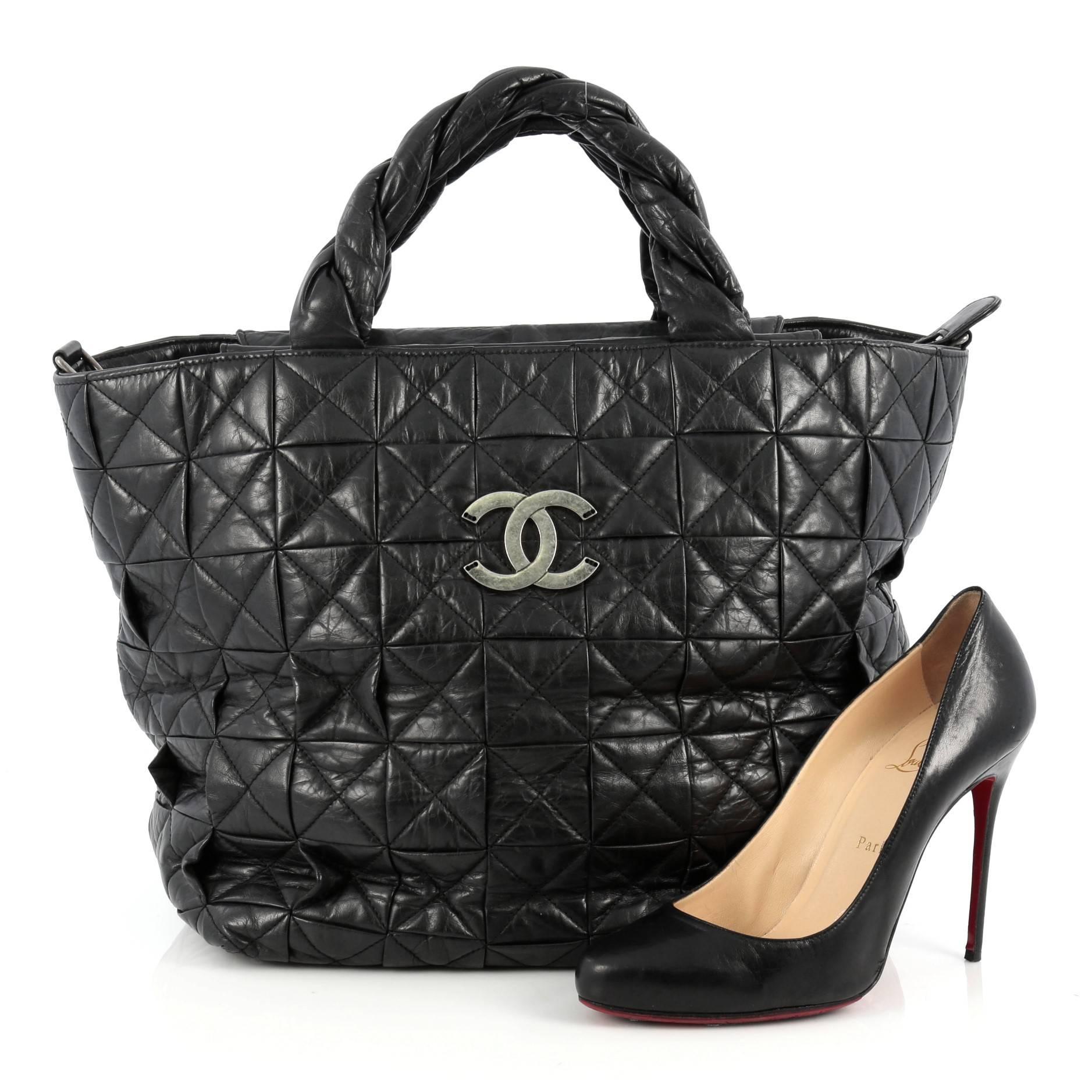 This authentic Chanel Origami Tote Quilted Aged Calfskin Large is an excellent and versatile tote, ideal for everyday use. Crafted from black quilted aged calfskin leather, this bag features dual top twisted calfskin leather handles, frontal aged