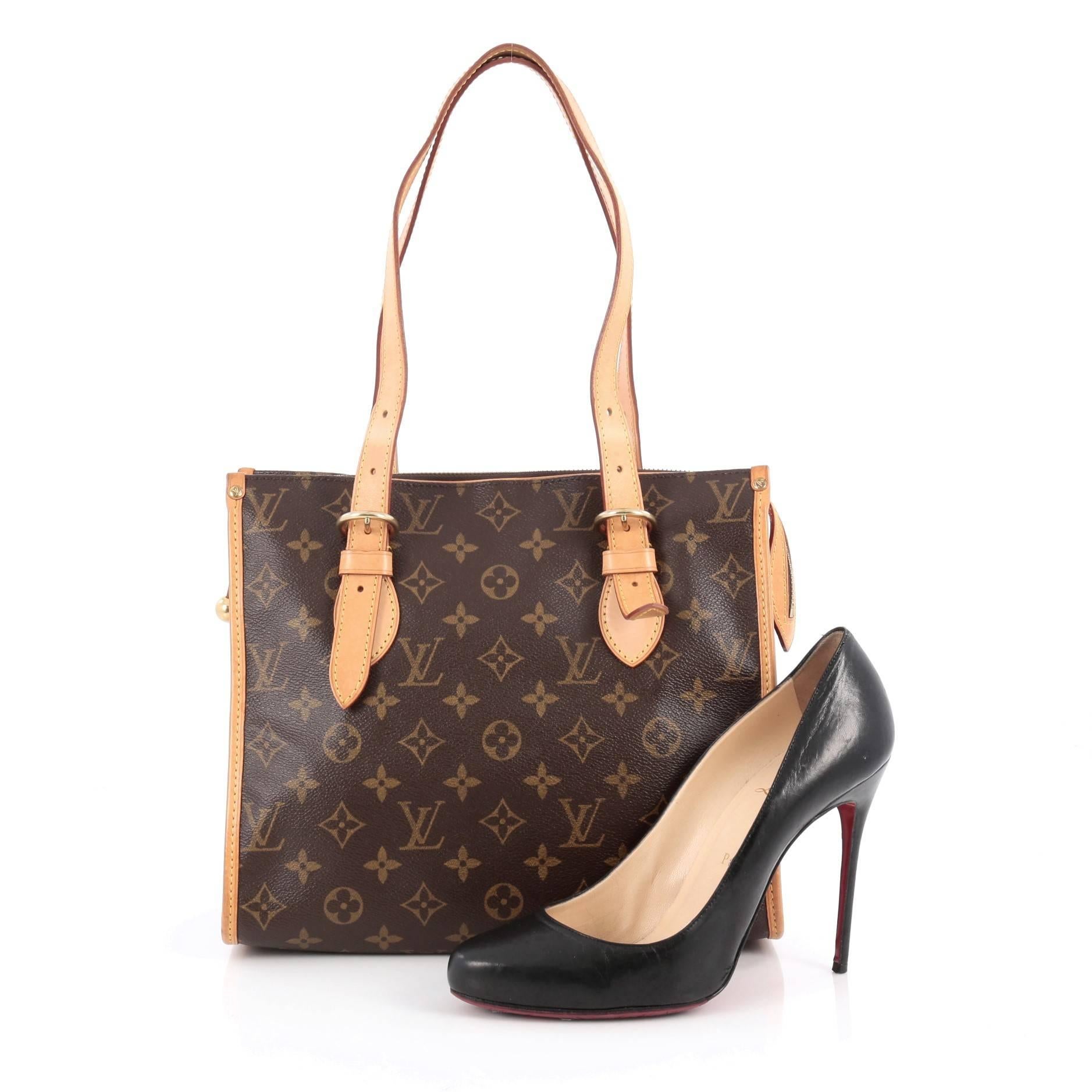 This authentic Louis Vuitton Popincourt Tote Monogram Canvas Haut is a practical yet iconic bag that is sure to be a wardrobe staple. Crafted from Louis Vuitton's iconic brown monogram coated canvas, this bag features cowhide vachetta leather