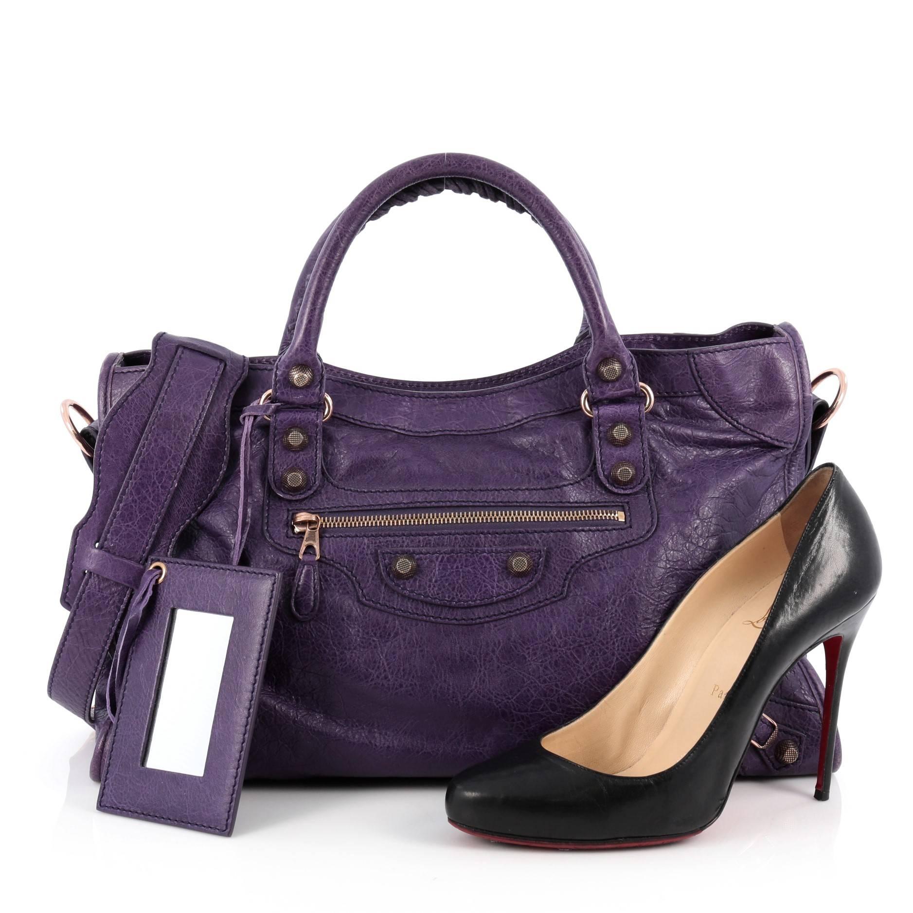 This authentic Balenciaga City Giant Studs Handbag Leather Medium is for the on-the-go fashionista. Constructed from crocus purple leather, this popular bag features dual braided woven tall handles, exterior front zip pocket, iconic Balenciaga giant