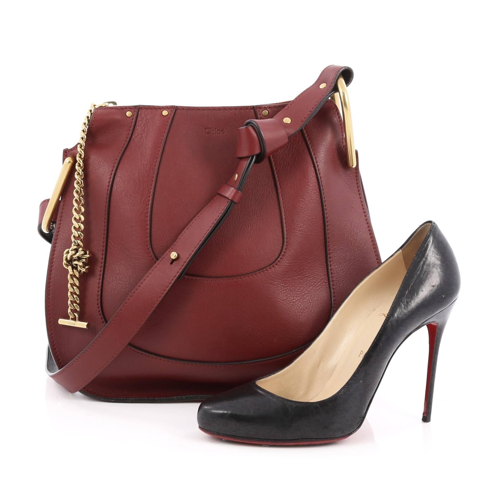 This authentic Chloe Hayley Hobo Leather Small mixes casual-bohemian styling with luxurious edge made for the Chloe girl. Crafted from dark red leather, this hobo bag features adjustable shoulder strap, chain insets, saddle-shaped silhouette, and