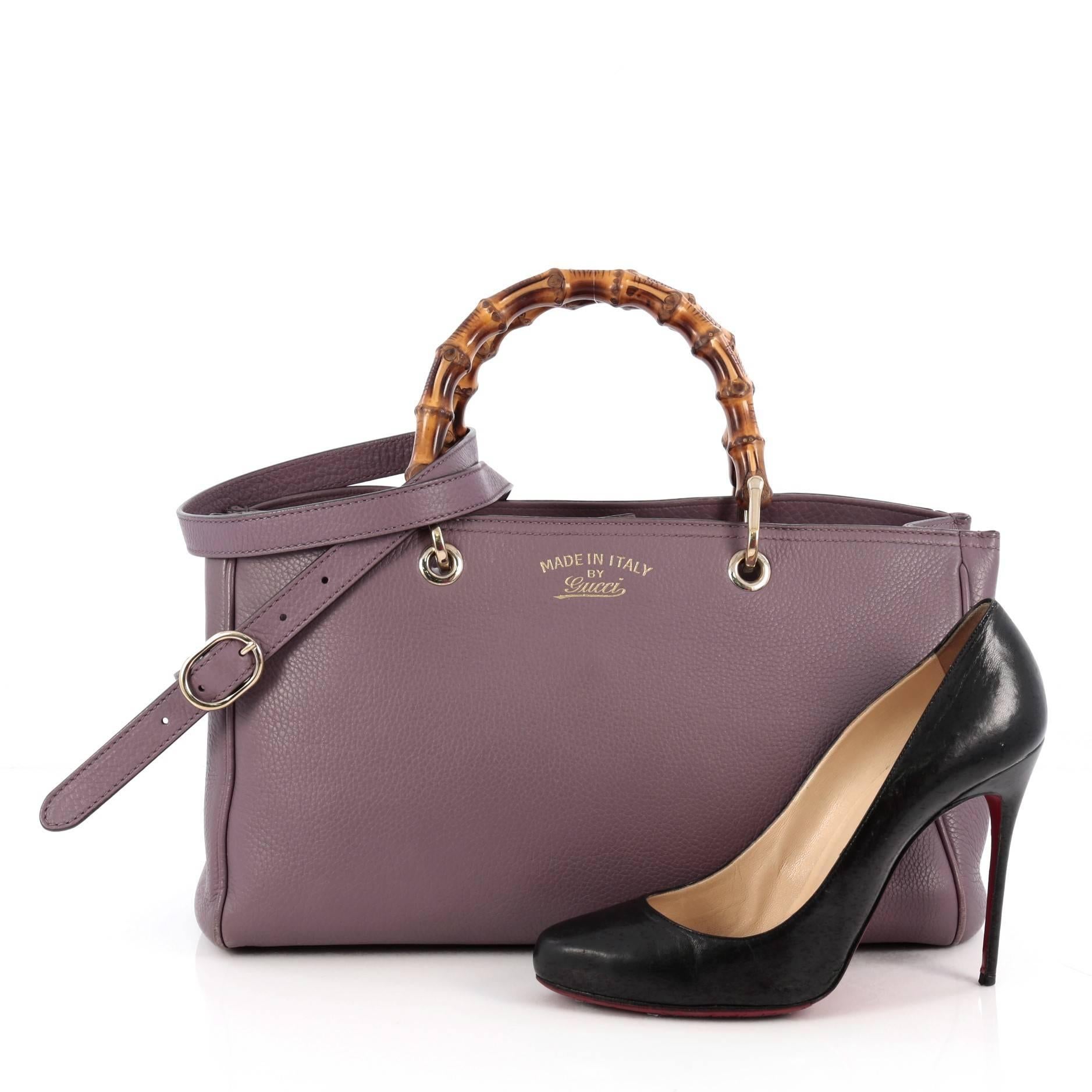 This authentic Gucci Bamboo Shopper Tote Leather Medium is a classic must-have. Crafted from purple leather, this simple yet stylish tote features Gucci's signature sturdy bamboo handles, protective base studs, stamped logo at the front, and bamboo