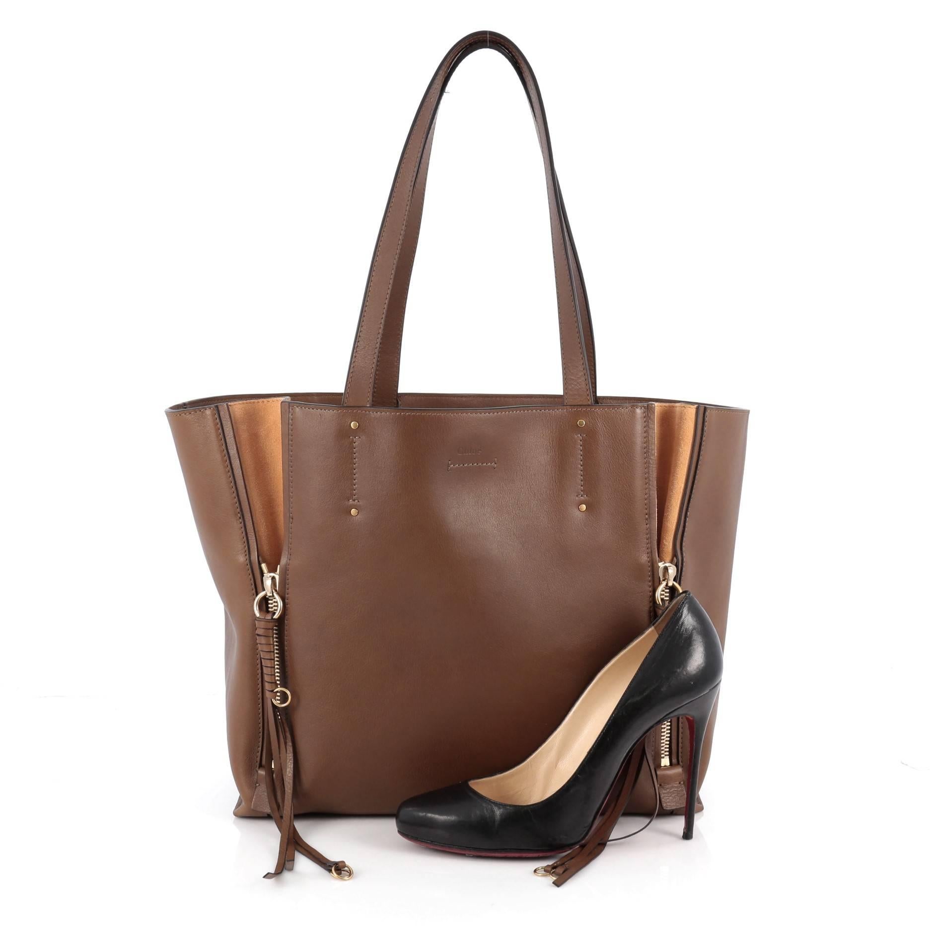 This authentic Chloe Milo Shopping Tote Leather Medium is a perfect bag for everyday excursions that's fresh and contemporary for the new season. Crafted from brown leather, this stylish bag features dual flat top handles, contrast suede gussets and