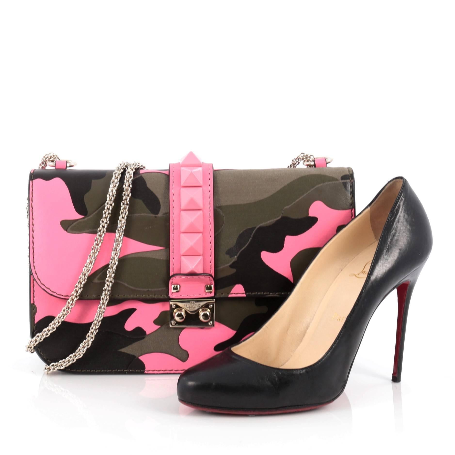 This authentic Valentino Glam Lock Shoulder Bag Camo Leather and Canvas Medium presented in the brand's Spring 2014 Collection is a fun, exciting and bold accessory perfect for nights out. Crafted from pink, khaki green camo leather and canvas with
