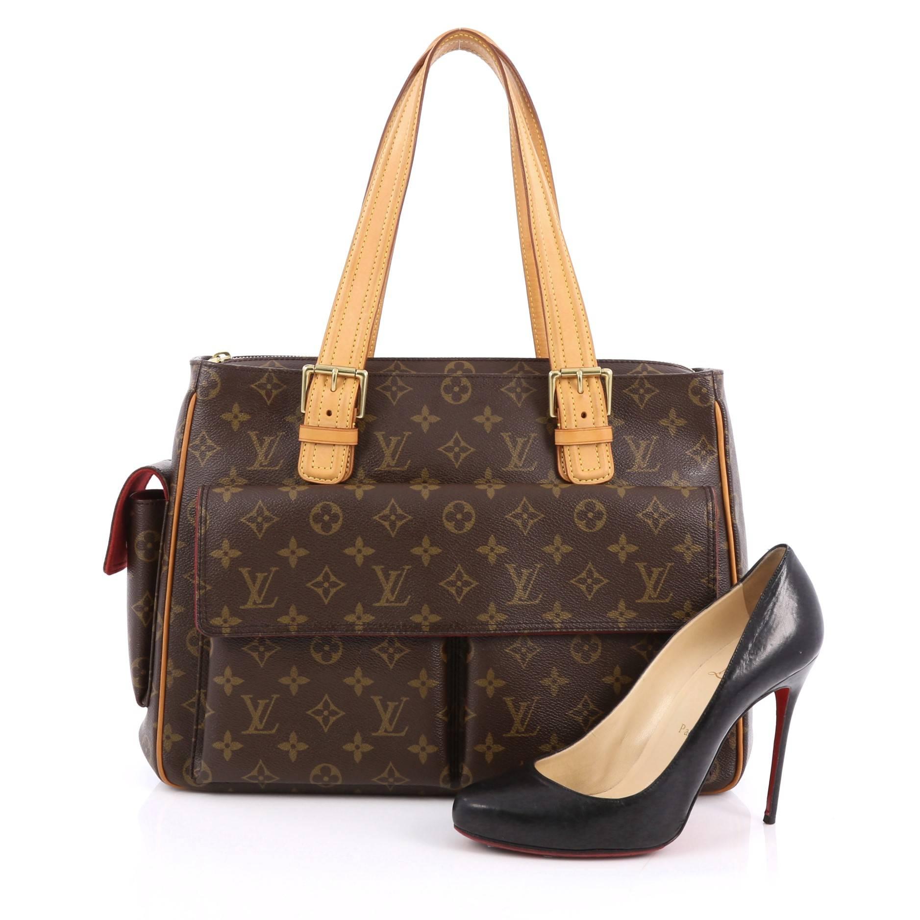 This authentic Louis Vuitton Multipli Cite Handbag Monogram Canvas showcases a simple design made for everyday use. Crafted from Louis Vuitton's iconic brown monogram coated canvas, this tote features dual flat vachetta leather straps with buckle