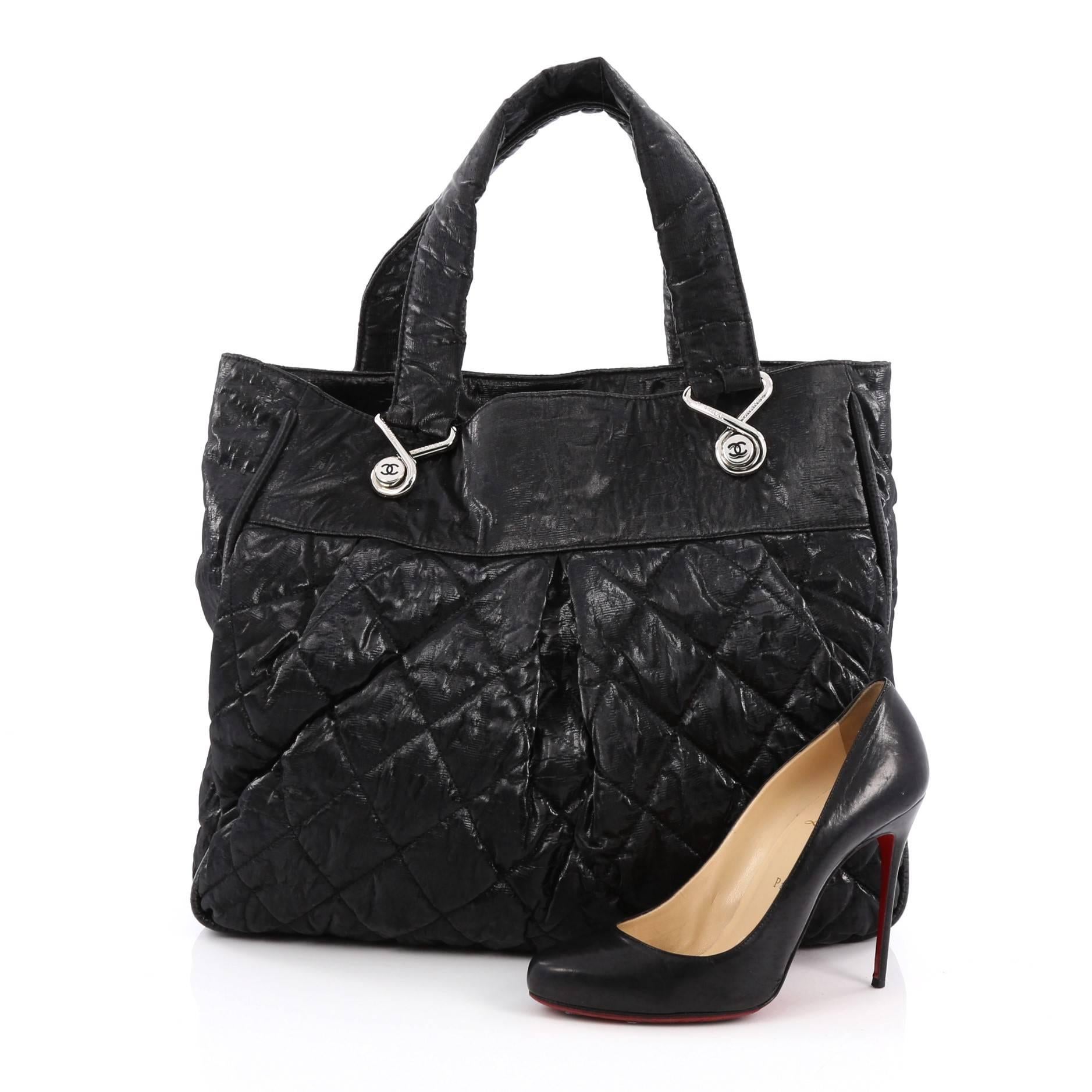 This authentic Chanel Le Marais Tote Quilted Coated Canvas Large from the brand's Pre-Fall 2009 Collection is a marvelous tote that is stylish and fabulously functional for everyday use. Crafted from black crinkled quilted coated canvas, this chic
