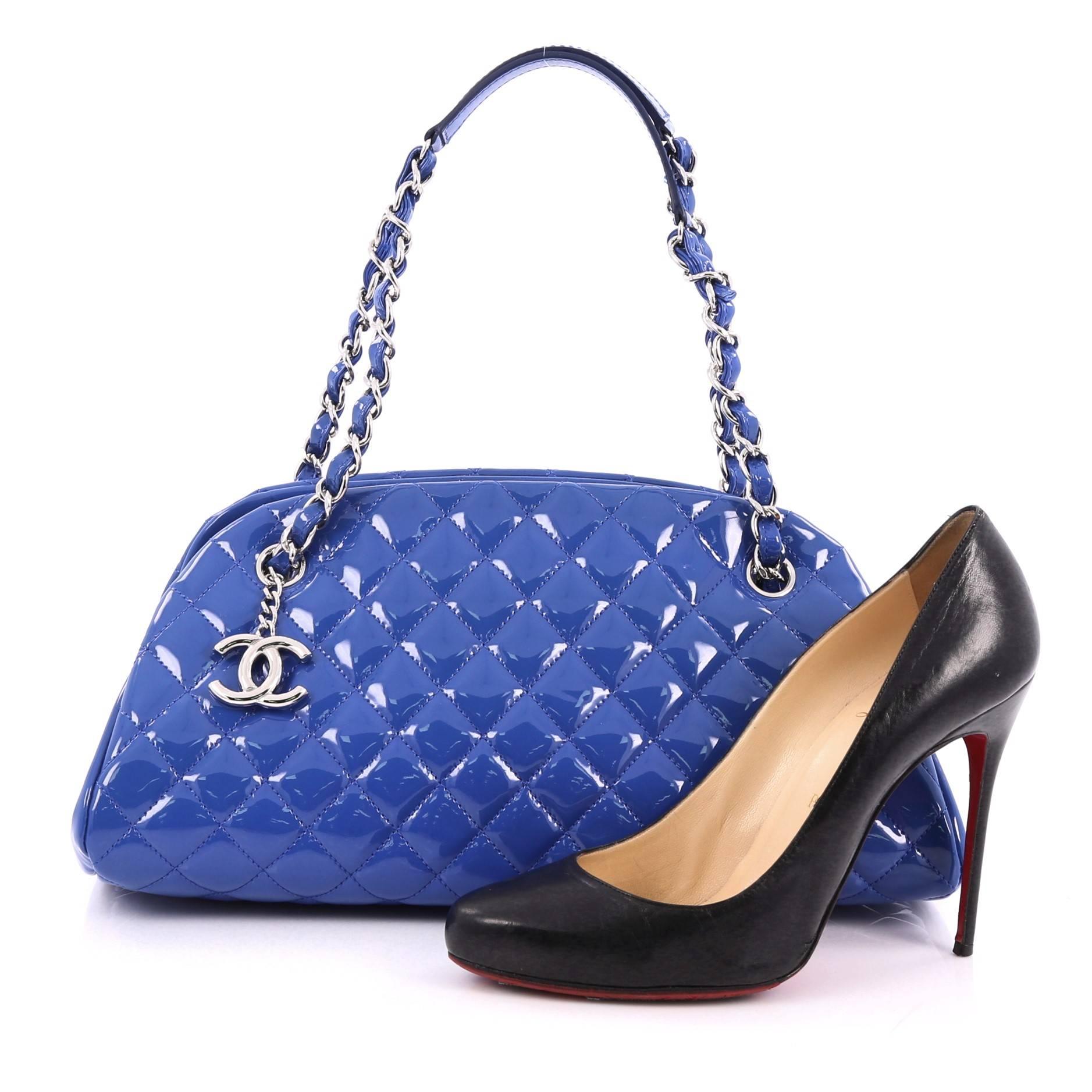 This authentic Chanel Just Mademoiselle Handbag Quilted Patent Medium showcases a sleek style that complements any look. Crafted from royal blue patent leather in Chanel's iconic diamond quilt pattern, this bag features woven-in leather chain straps
