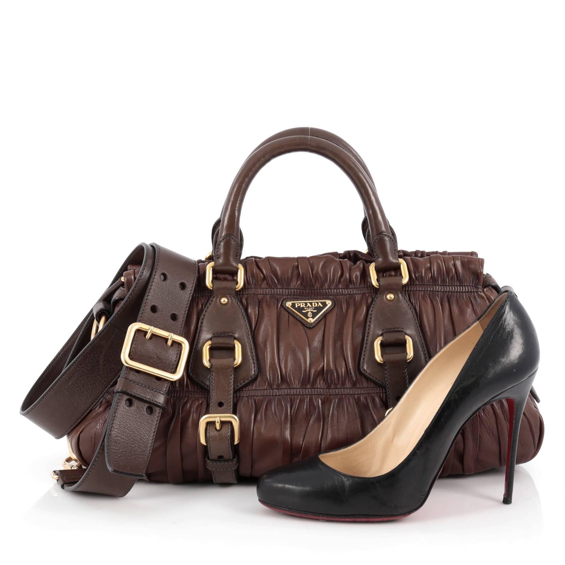 This authentic Prada Gaufre Convertible Satchel Nappa Leather Medium is beautifully and intricately crafted, made for everyday use. Constructed in brown nappa leather, this satchel features dual-rolled leather handles with buckle details, trademark
