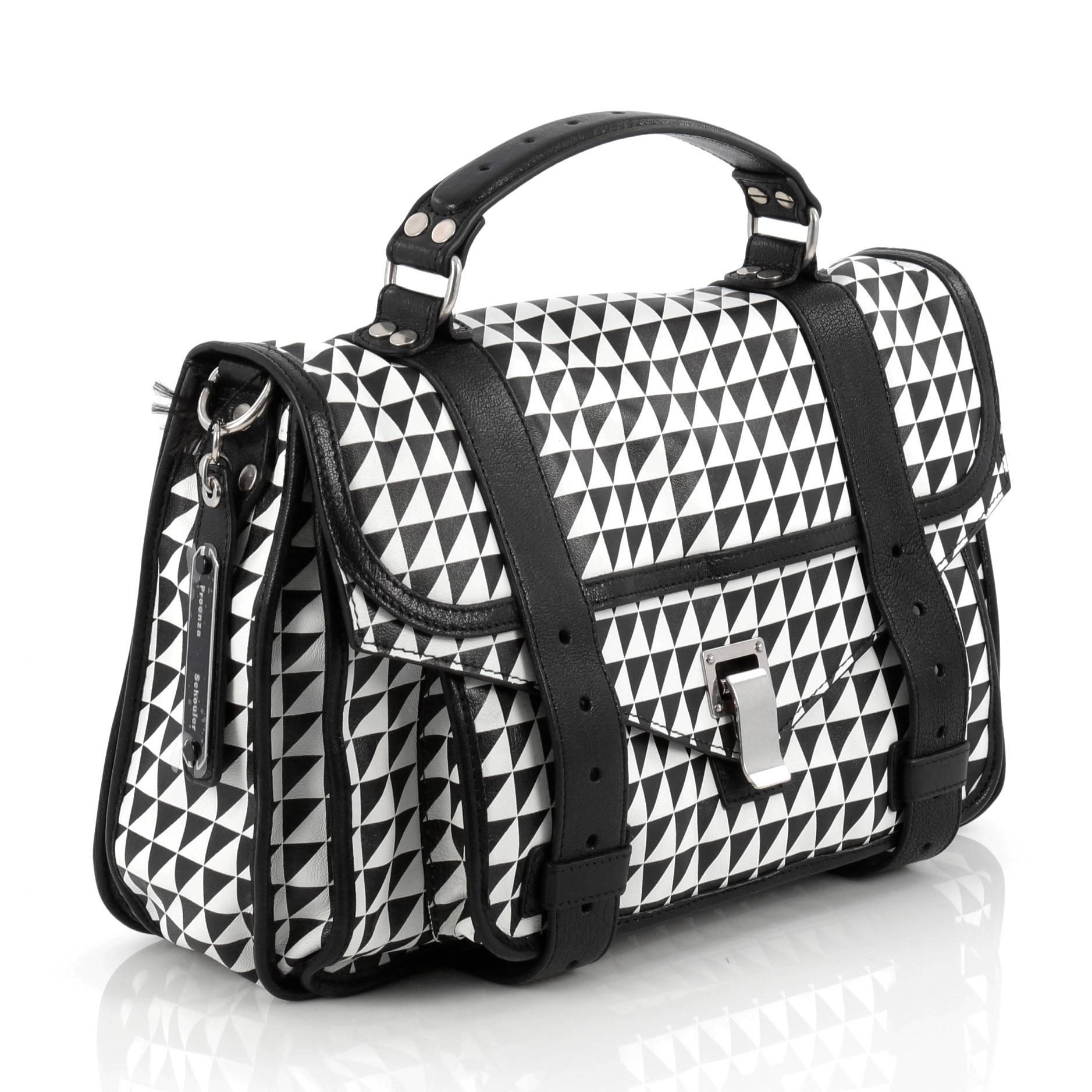 This authentic Proenza Schouler PS1 Satchel Printed Leather Medium is the ideal way to travel with style and functionality. Constructed from black and white leather with black leather trims, this popular satchel features an envelope-style front flap