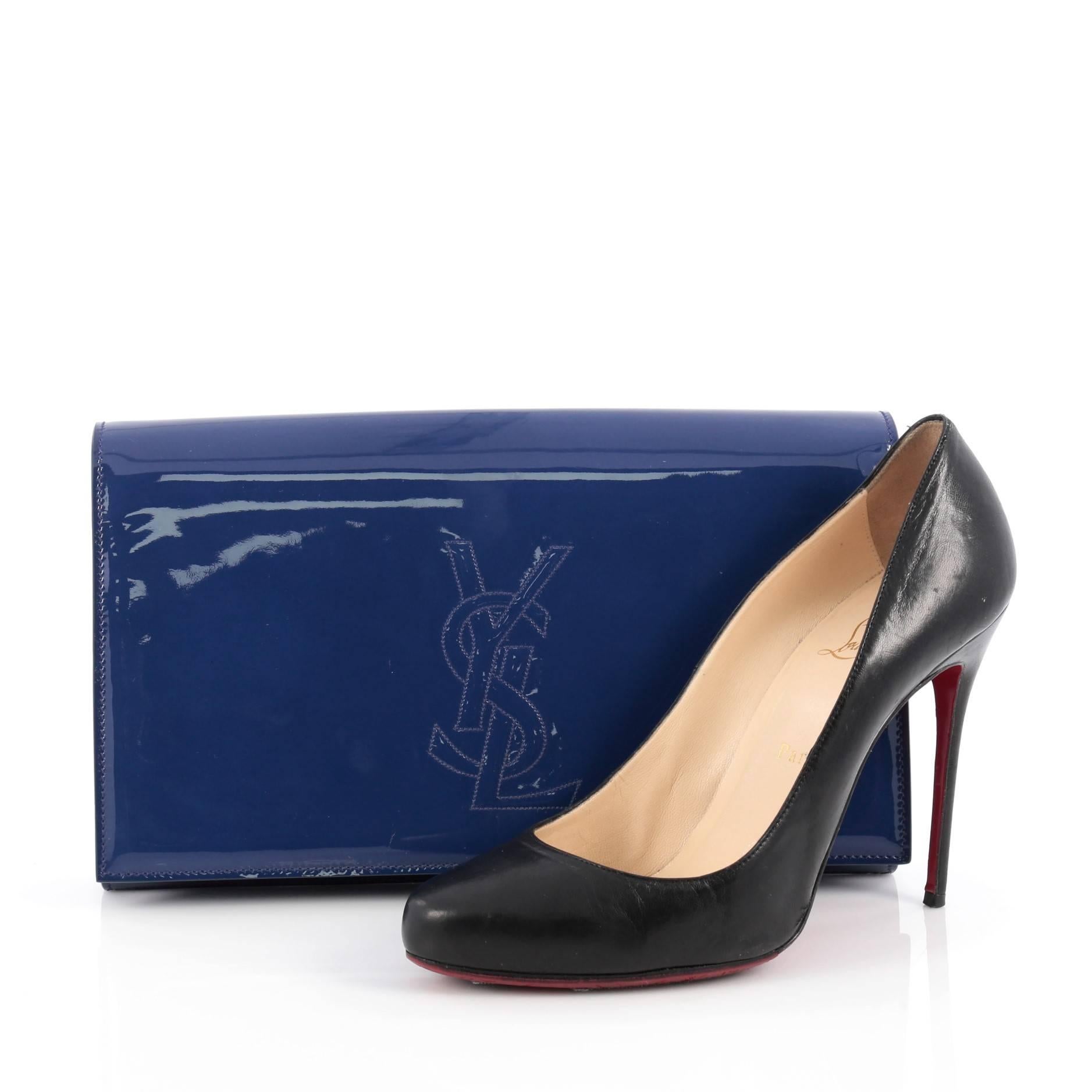 This authentic Saint Laurent Belle de Jour Clutch Patent Large is a chic and glamorous accessory to complement nightly looks. Crafted from luxurious blue patent leather, this clutch features a stitched YSL monogram logo and gold-tone hardware