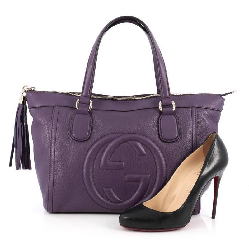 This authentic Gucci Soho Zip Tote Leather Small is perfect for daily use and weekend getaways. Crafted from purple leather, this elegant carry-all tote features dual-flat leather handles, stitched interlocking GG logo, leather tassel zip pulls,