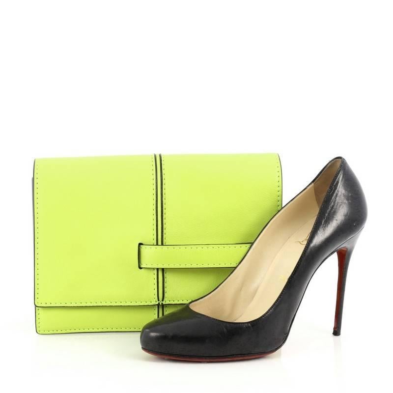 This authentic Valentino My Own Code Clutch Leather is a versatile piece that complements both casual and dressy looks. Constructed from neon yellow leather, this clutch features black hand painted edges, single front handle strap that comfortably