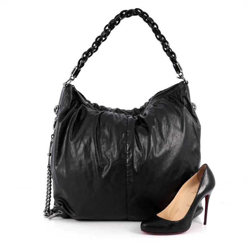 This authentic Gucci Galaxy Convertible Hobo Leather Large is an edgy, exotic-chic hobo made for everyday excursions. Crafted from black gleather, this hobo features chunky black resin looping shoulder strap, exterior side zip pocket with long