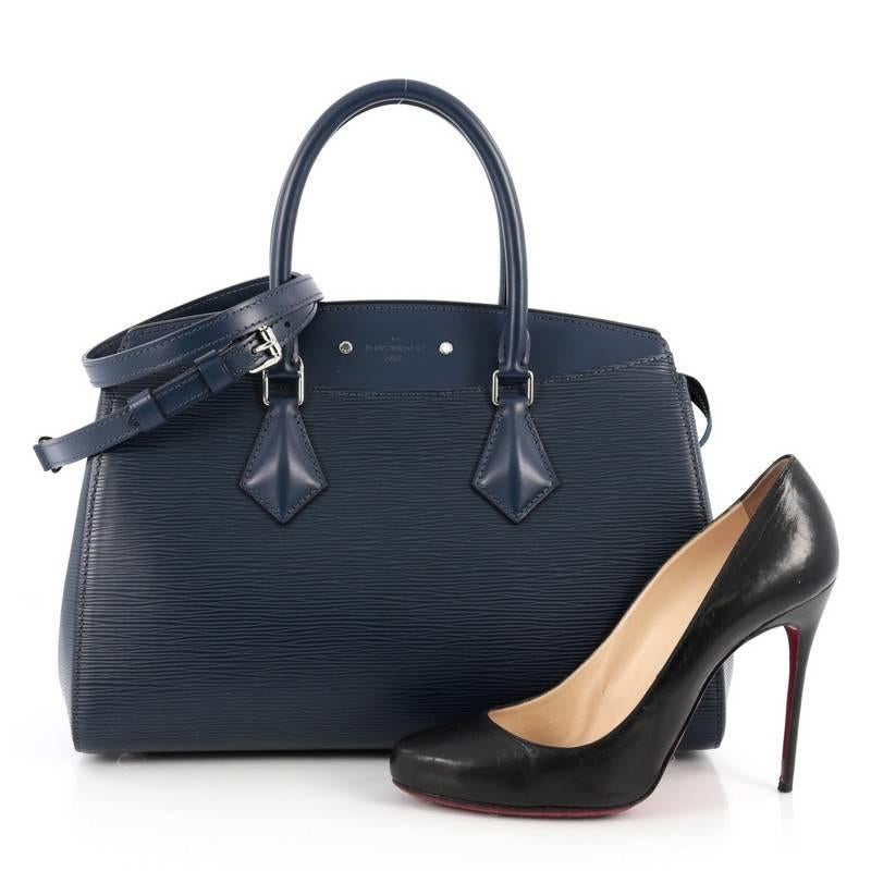 This authentic Louis Vuitton Soufflot NM Handbag Epi Leather MM is a new day-to-day business tote exuding sleek style and versatile functionality. Crafted from blue epi leather, this chic bag features dual-rolled leather handles, adjustable shoulder