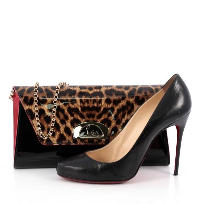 This authentic Christian Louboutin Vero Dodat Clutch Patent, inspired by the covered passageway that houses the original boutique, is the perfect accessory to add to your collection. Crafted from black, red and leopard print patent leather, this