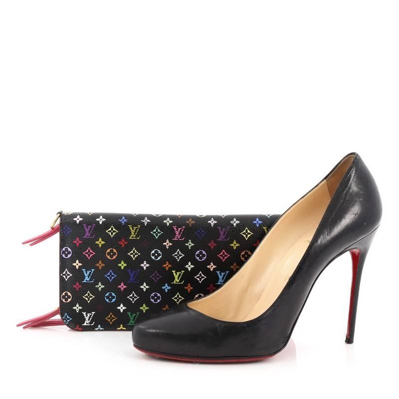 This authentic Louis Vuitton Insolite Wallet Monogram Multicolor is a great functional wallet. Crafted from black monogram multi-color coated canvas, this eye-catching compact accessory features a zippered pocket and gold-tone hardware accents. The