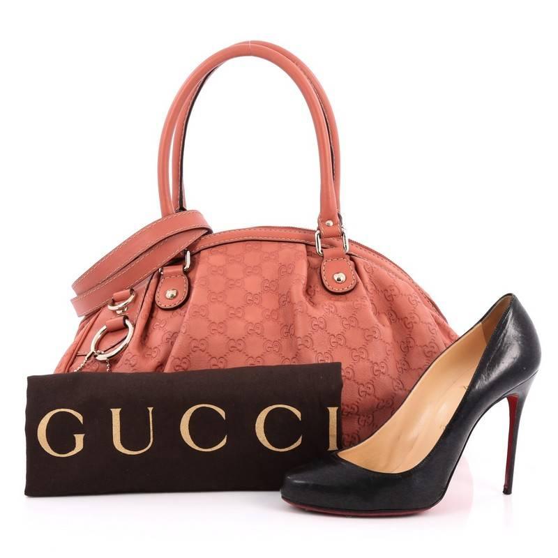 This authentic Gucci Sukey Convertible Boston Bag Guccissima Leather is a chic and sophisticated bag made for everyday use. Crafted from coral pink guccissima, this timeless bag features dual-rolled leather handles, flat detachable leather shoulder
