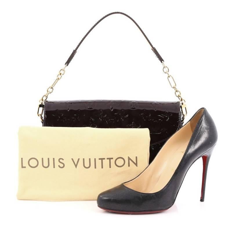 This authentic Louis Vuitton Rodeo Drive Handbag Monogram Vernis is perfect for day-to-night. Crafted in amarante monogram vernis, this handbag features gold chain straps with leather pads, frontal flap with gold plated Louis Vuitton handwritten