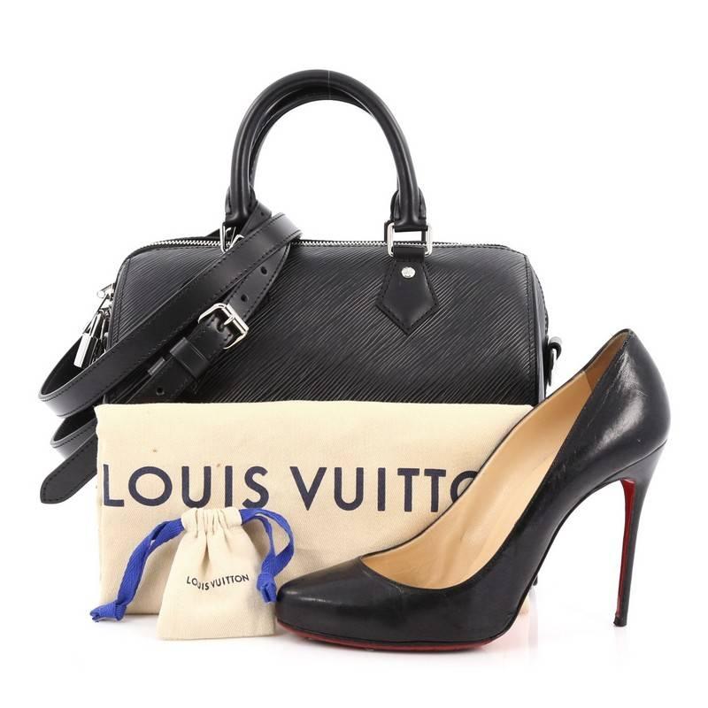 This authentic Louis Vuitton Speedy Bandouliere Bag Epi Leather 25 is a modern must-have. Constructed from Louis Vuitton's luxurious black epi leather, this iconic and re-imagined Speedy features dual-rolled leather handles, protective base studs