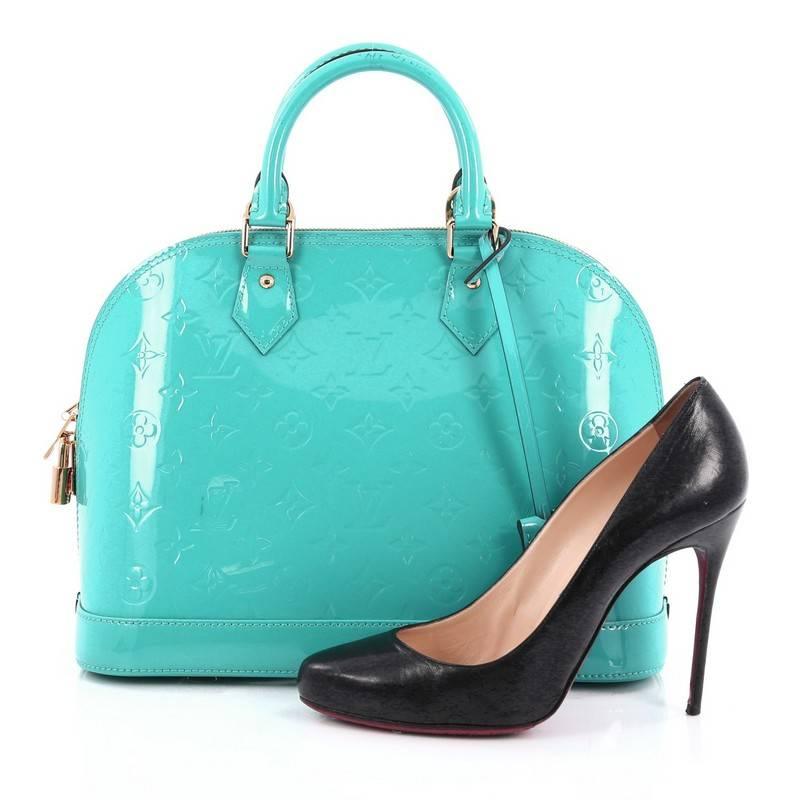 This authentic Louis Vuitton Alma Handbag Monogram Vernis PM is a fresh and elegant spin on a classic style that is perfect for all seasons. Crafted from Louis Vuitton's turquoise monogram vernis leather, this dome-shaped satchel features