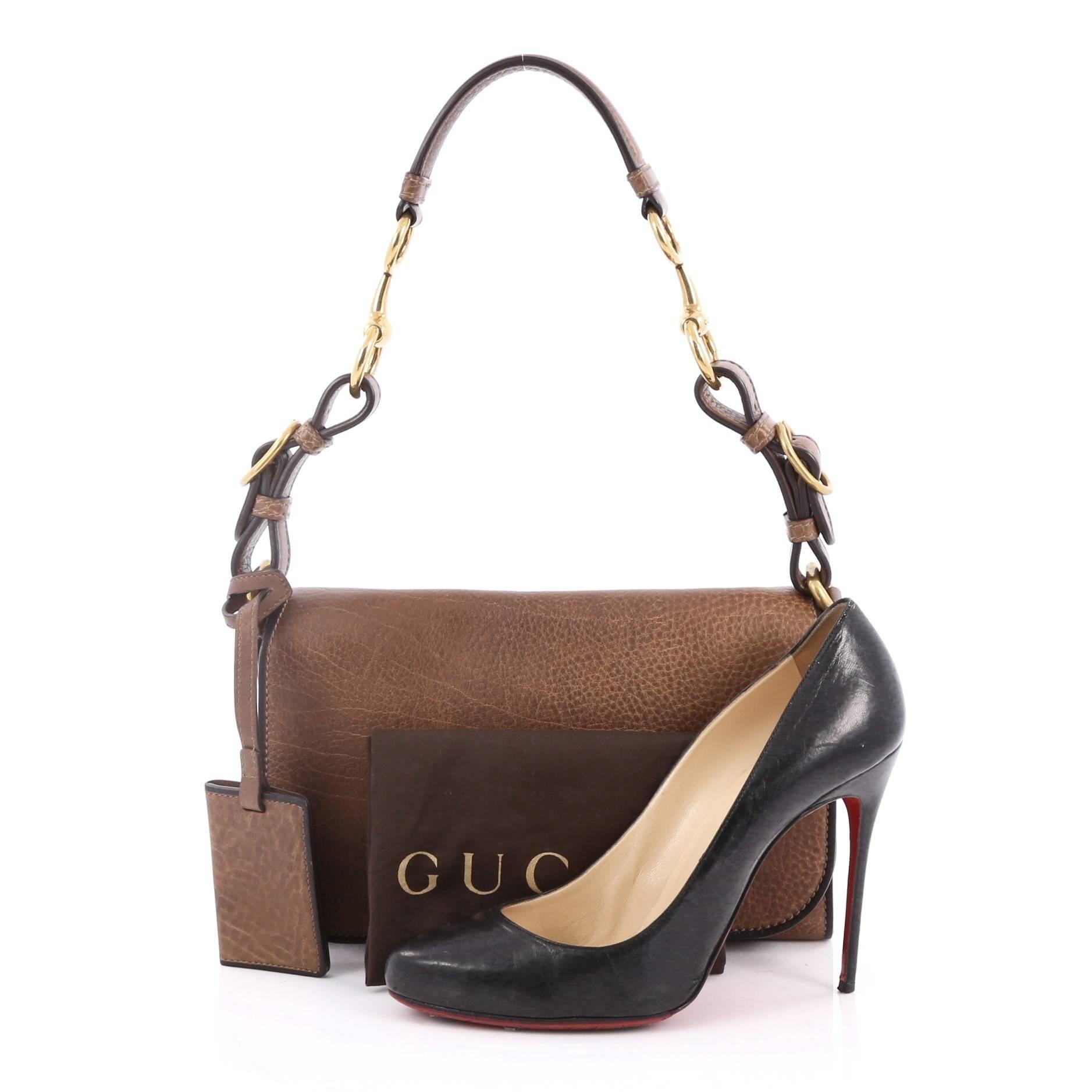 This authentic Gucci Harness Shoulder Bag Distressed Pebbled Leather Small presented in the brand's Cruise 2014 Collection is perfect for everyday use. Crafted in brown distressed pebbled leather, this heritage-inspired industrial flap bag features
