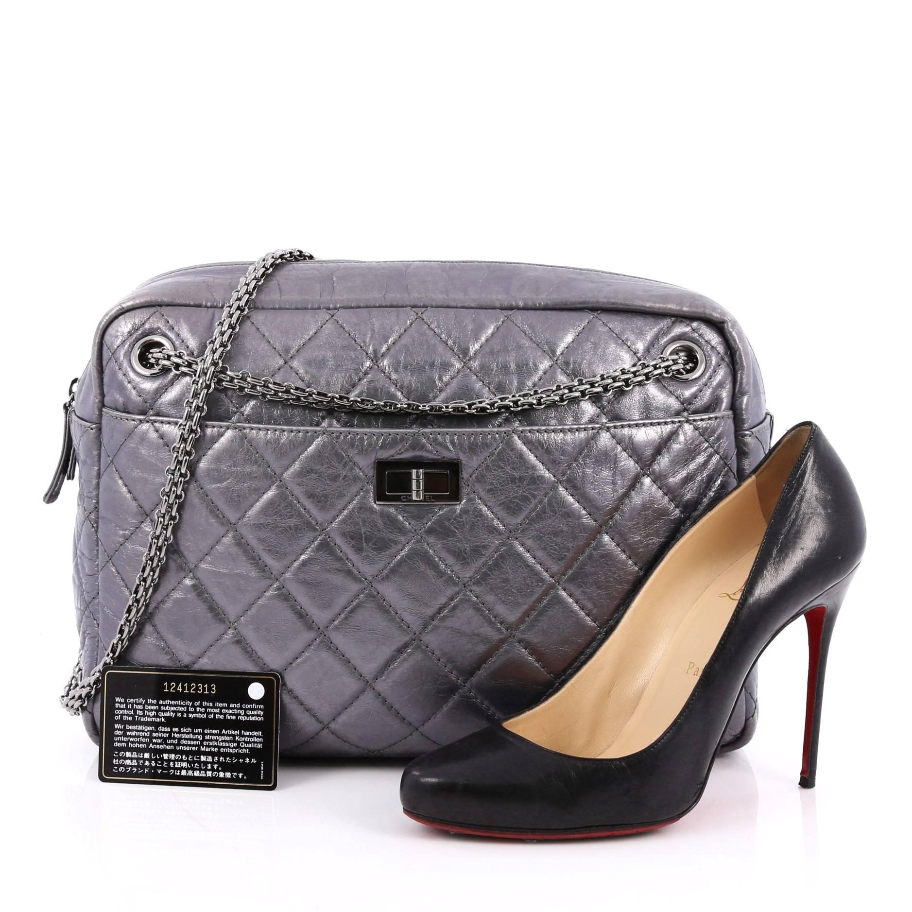 This authentic Chanel Reissue Camera Bag Quilted Aged Calfskin Large is a timeless and iconic piece made for any fashionista. Crafted in metallic silver diamond quilted calfskin leather, this camera-style bag features iconic silver bijoux chain