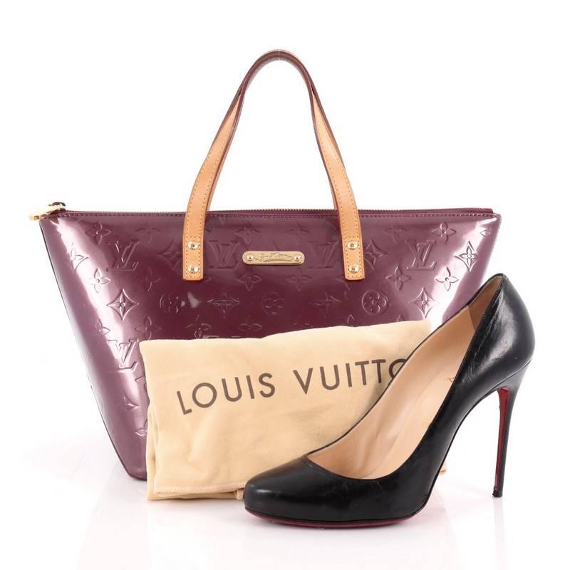 This authentic Louis Vuitton Bellevue Handbag Monogram Vernis PM is a stylish yet functional tote perfect for everyday use. Crafted from Louis Vuitton's amethyst purple monogram vernis embossed leather, this chic tote features dual flat vachetta