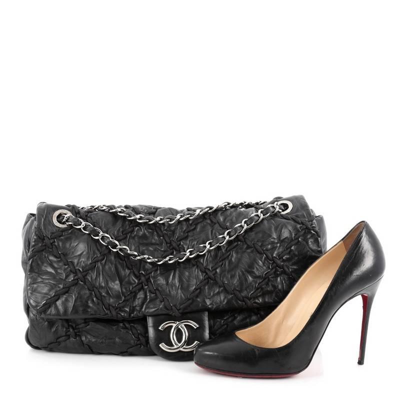 This authentic Chanel Ultra Stitch Flap Bag Quilted Calfskin Jumbo, presented in the brand's 2010 Collection, is a funky, modern twist on its classic design made for modern fashionistas. Crafted from black quilted calfskin leather, this subtly