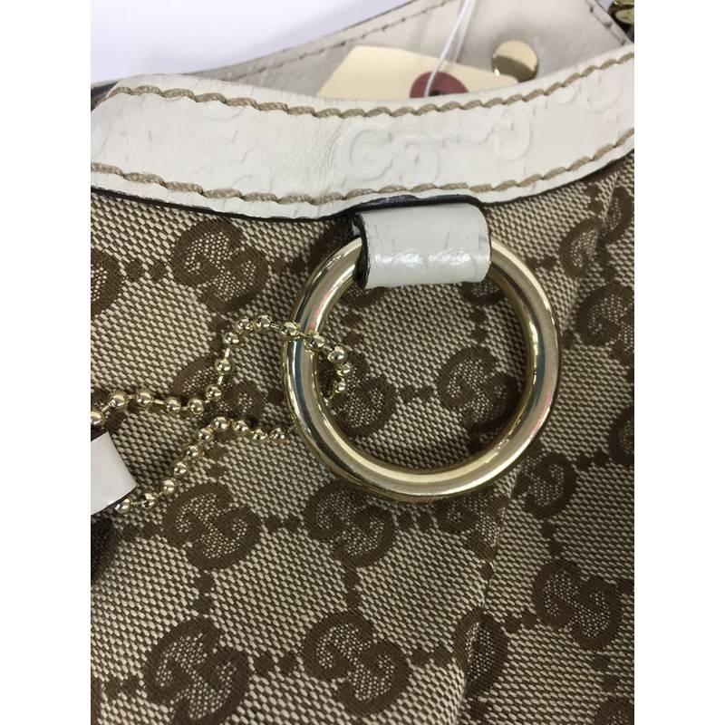 This authentic Gucci Sukey Tote GG Canvas Large is perfect for any casual or sophisticated outfit. Constructed from Gucci's beige GG canvas with off-white leather trims, this roomy tote features dual-rolled leather handles that sit comfortably on