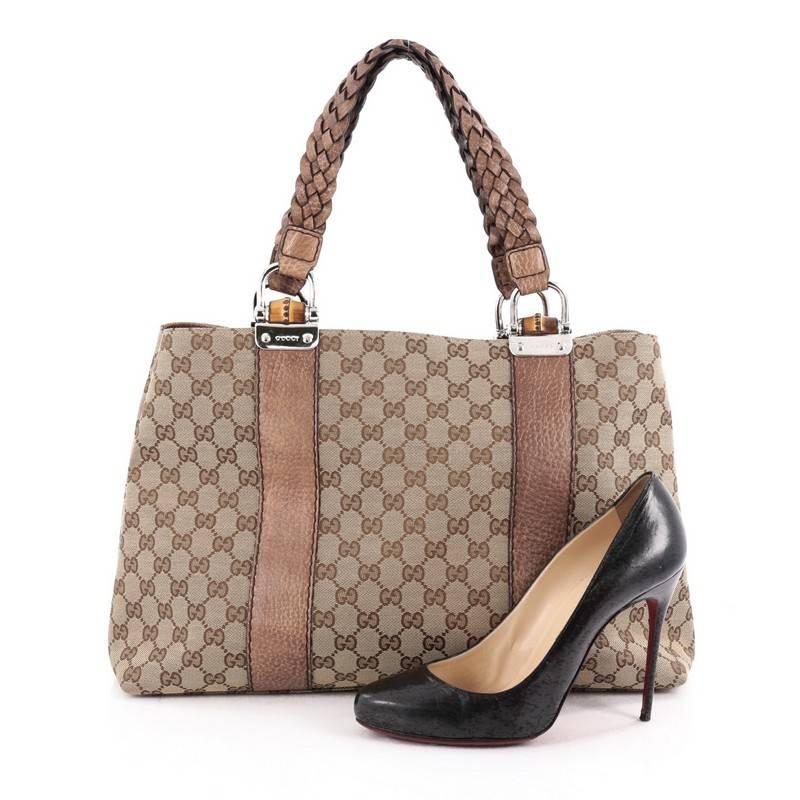 This authentic Gucci Bamboo Bar Tote GG Canvas Medium is a simple yet sophisticated daily bag for the on-the-go woman. Crafted from brown GG canvas, this beautiful and functional tote features braided dual strap handles with bamboo details and