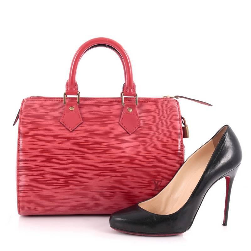 This authentic Louis Vuitton Speedy Handbag Epi Leather 30 is a timeless favorite of many. Crafted in red epi leather, this bag features dual-rolled handles, subtle stamped LV logo, exterior side slip pocket and gold-tone hardware accents. Its top