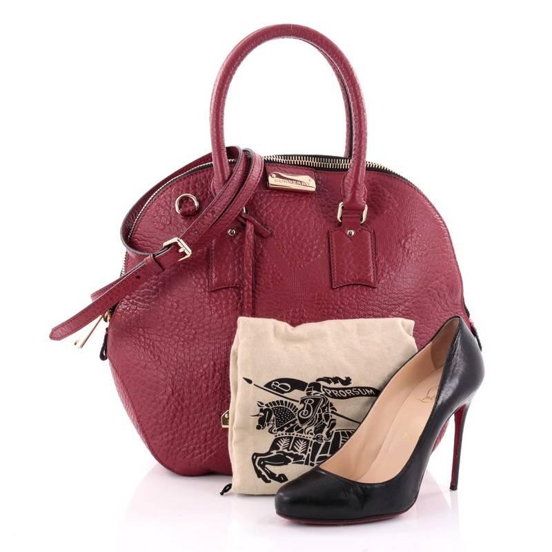 This authentic Burberry Orchard Bag Embossed Check Leather Medium has an elegant and simplistic design with a compact silhouette that is ideal for everyday use. Crafted from supple red leather with embossed check details, this heritage-inspired bag