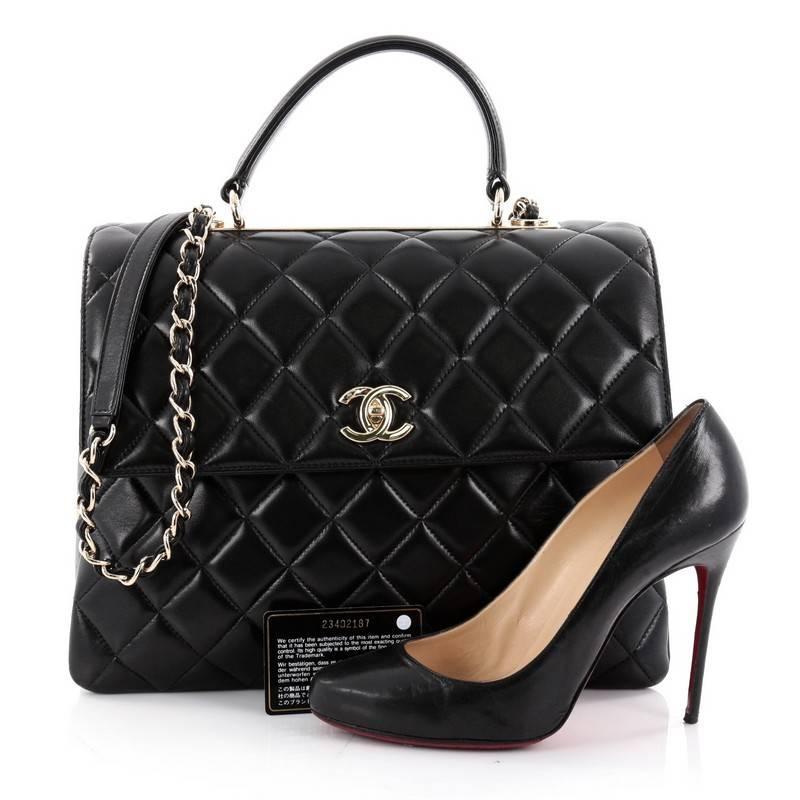 This authentic Chanel Trendy CC Top Handle Bag Quilted Lambskin Large is a marvelous day or evening bag from the brands' Chanel's 2015 collection. Crafted from black quilted leather, this chic bag features flat leather top handle, woven-in leather