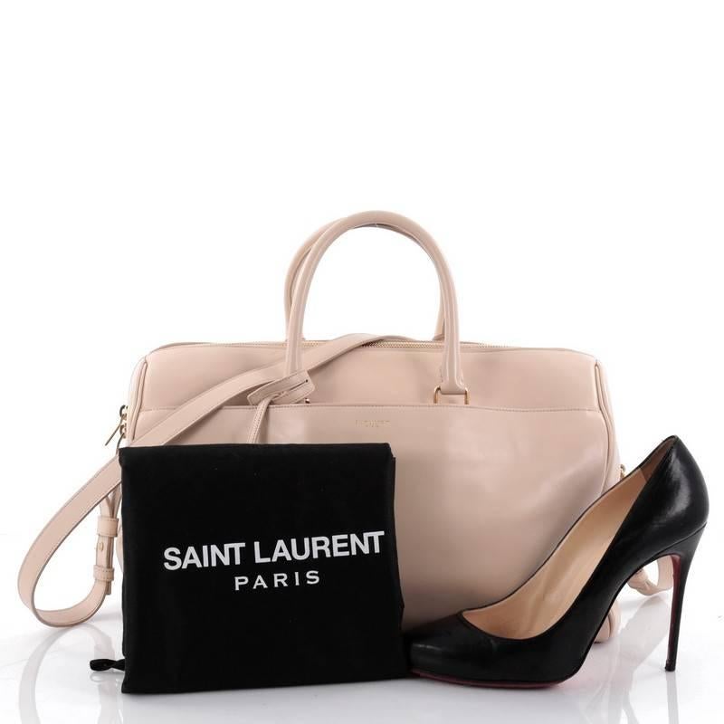 This authentic Saint Laurent Classic Duffle Bag Leather 12 is a sleek, modern and an elegant duffle bag to travel in style with. Crafted in nude leather, this alluring bag features dual-rolled leather handles, detachable strap that can be carried as