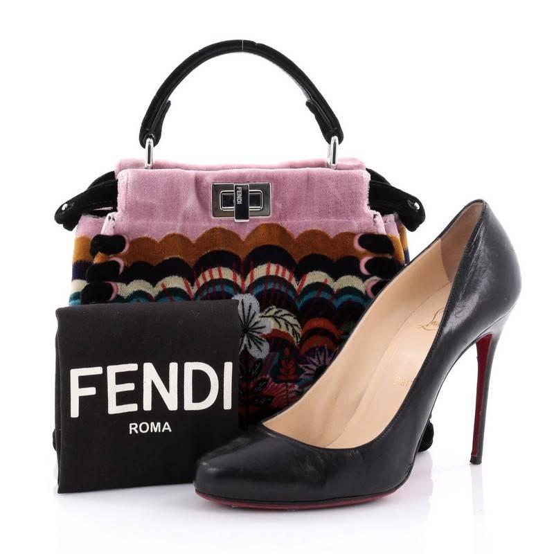 This authentic Fendi Peekaboo Handbag Embroidered Velvet Mini is one of Fendi's most sought-after design. Crafted from multicolored embroidered velvet, this mini-size satchel is accented with a top frame silhouette, flat velvet handle, dual