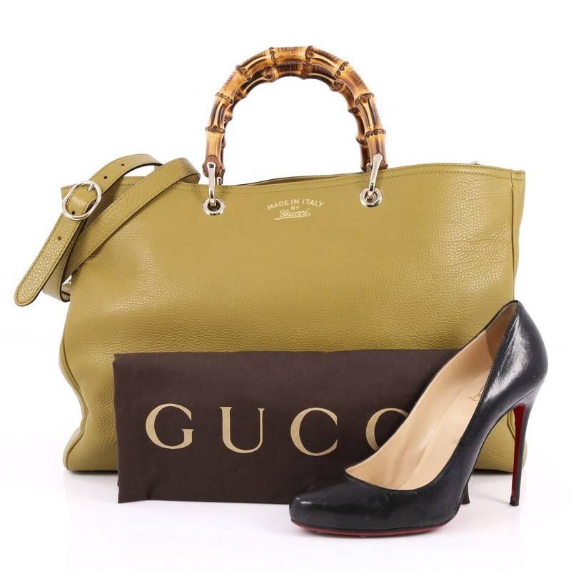 This authentic Gucci Bamboo Shopper Tote Leather Large is a classic must-have. Crafted from green leather, this simple yet stylish tote features Gucci's signature sturdy bamboo handles, protective base studs, stamped logo at the front, and bamboo