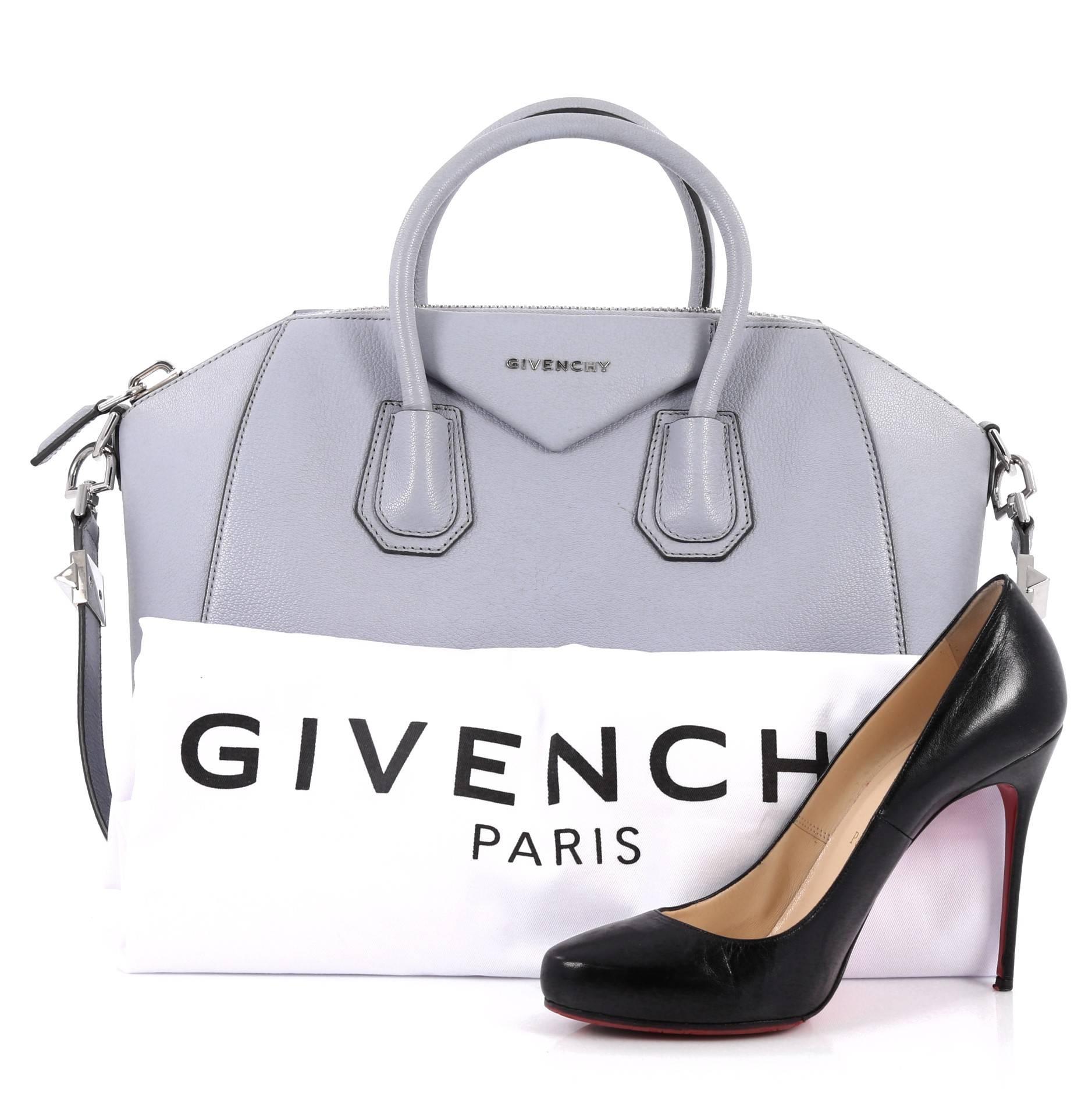 This authentic Givenchy Antigona Bag Leather Medium is a go-to fashion favorite. Crafted from periwinkle leather, this structured yet stylish tote features the brand's signature envelope flap detail with Givenchy logo, dual-rolled leather handles