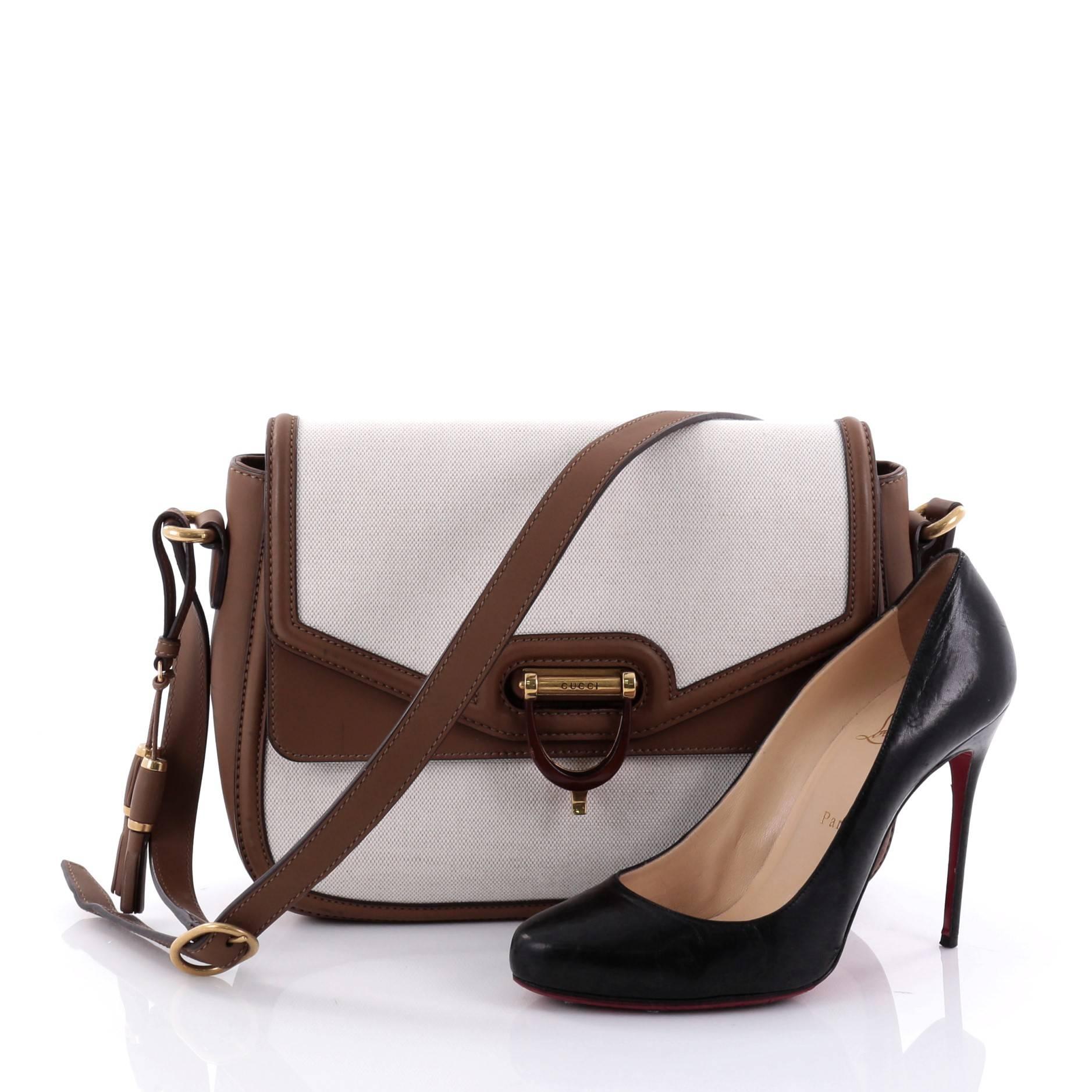 This authentic Gucci Derby Flap Shoulder Bag Canvas and Leather Medium is a stylish and chic bag perfect for your everyday use. Crafted in off-white canvas with brown leather trims, this bag features an adjustable strap, tassel detailing, front flap