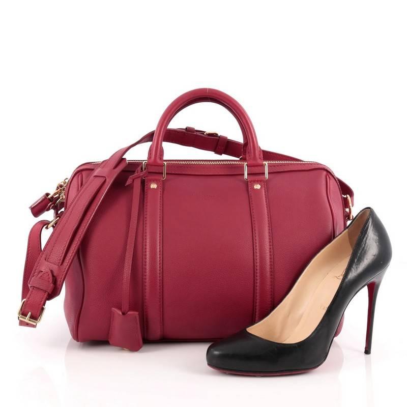 This authentic Louis Vuitton Sofia Coppola SC Bag Leather PM is a stylish and elegant everyday bag. Crafted from red leather, this simple yet refined duffle bag features sturdy rolled handles, adjustable shoulder strap, protective base studs and