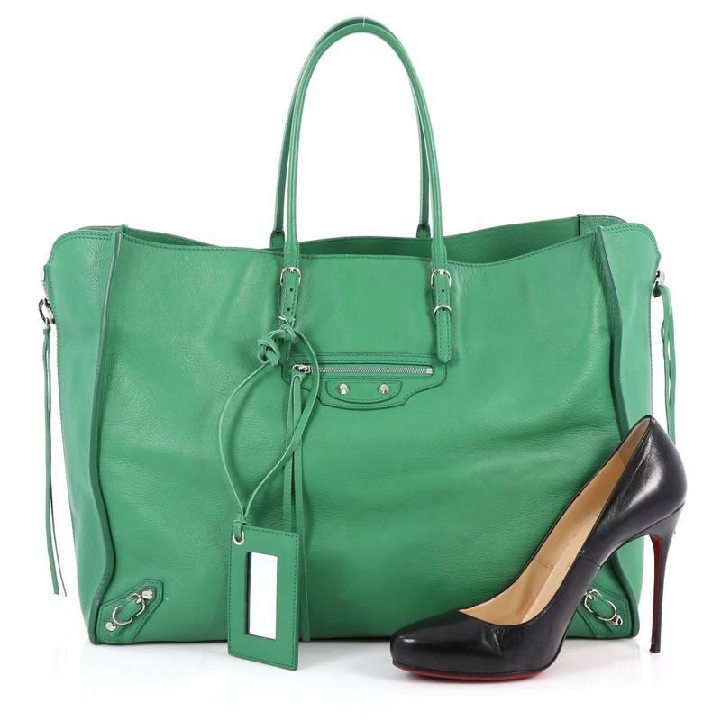 This authentic Balenciaga Papier A4 Zip Around Classic Studs Handbag Leather Large is a modern and minimalistic accessory perfect for everyday excursions. Crafted in kelly green leather, this lightweight tote features slim handles, zippered sides