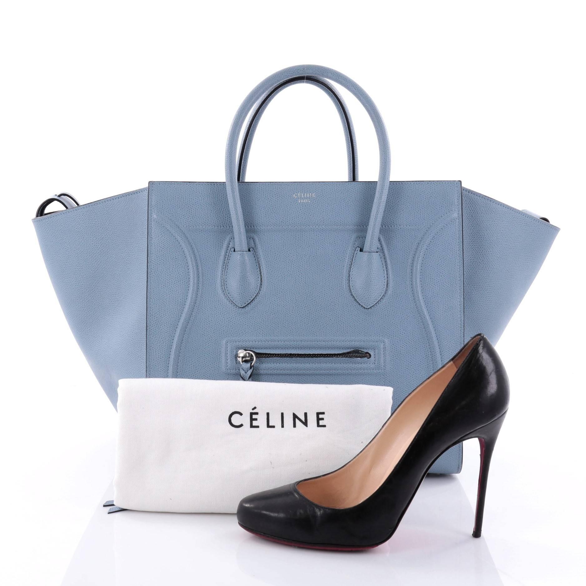 This authentic Celine Phantom Handbag Textured Leather Medium is one of the most sought-after bags beloved by fashionistas. Crafted from light blue textured leather, this minimalist tote features dual-rolled handles, an exterior front pocket,