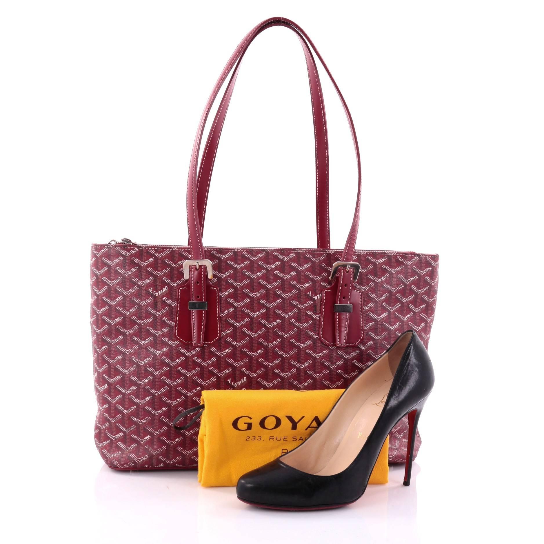 This authentic Goyard Okinawa Handbag Canvas PM displays a luxurious and casual sophistication perfect for travel or everyday use. Crafted from red Goyardine chevron coated canvas, this bag features dual flat shoulder straps with buckle detailing,