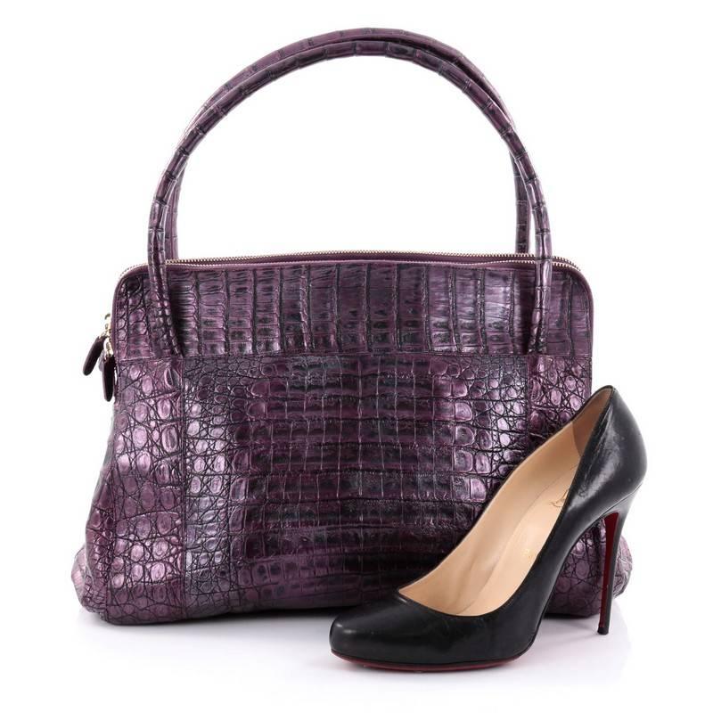 This authentic Nancy Gonzalez Linda Bag Crocodile Medium is an added statement piece to your collection. Crafted in luxurious genuine purple crocodile skin, this elegant bag features dual-rolled handles, exterior front pockets, protective feet and