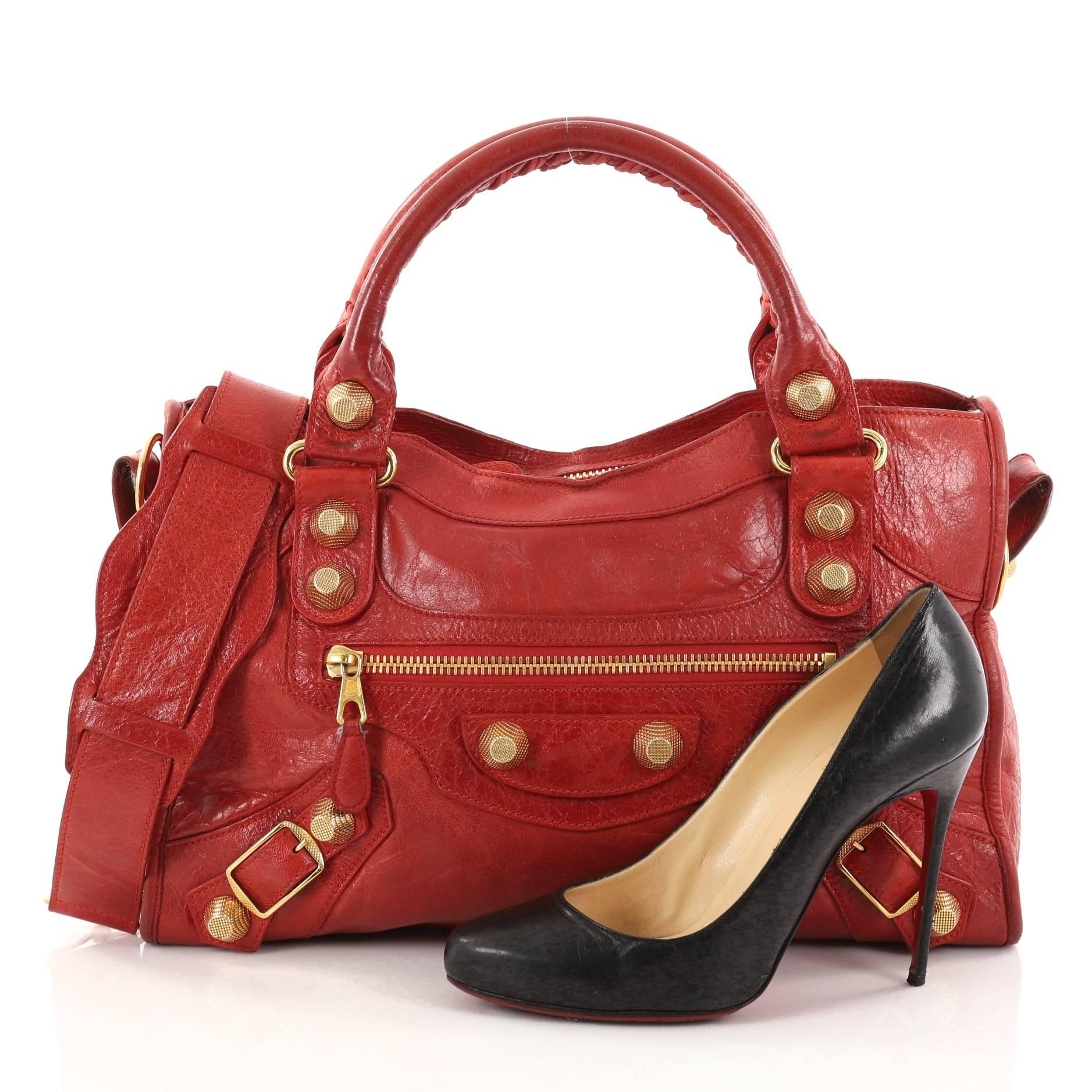 This authentic Balenciaga City Giant Studs Handbag Leather Medium is for the on-the-go fashionista. Constructed from red leather, this popular bag features dual braided woven tall handles, exterior front zip pocket, iconic Balenciaga giant studs and